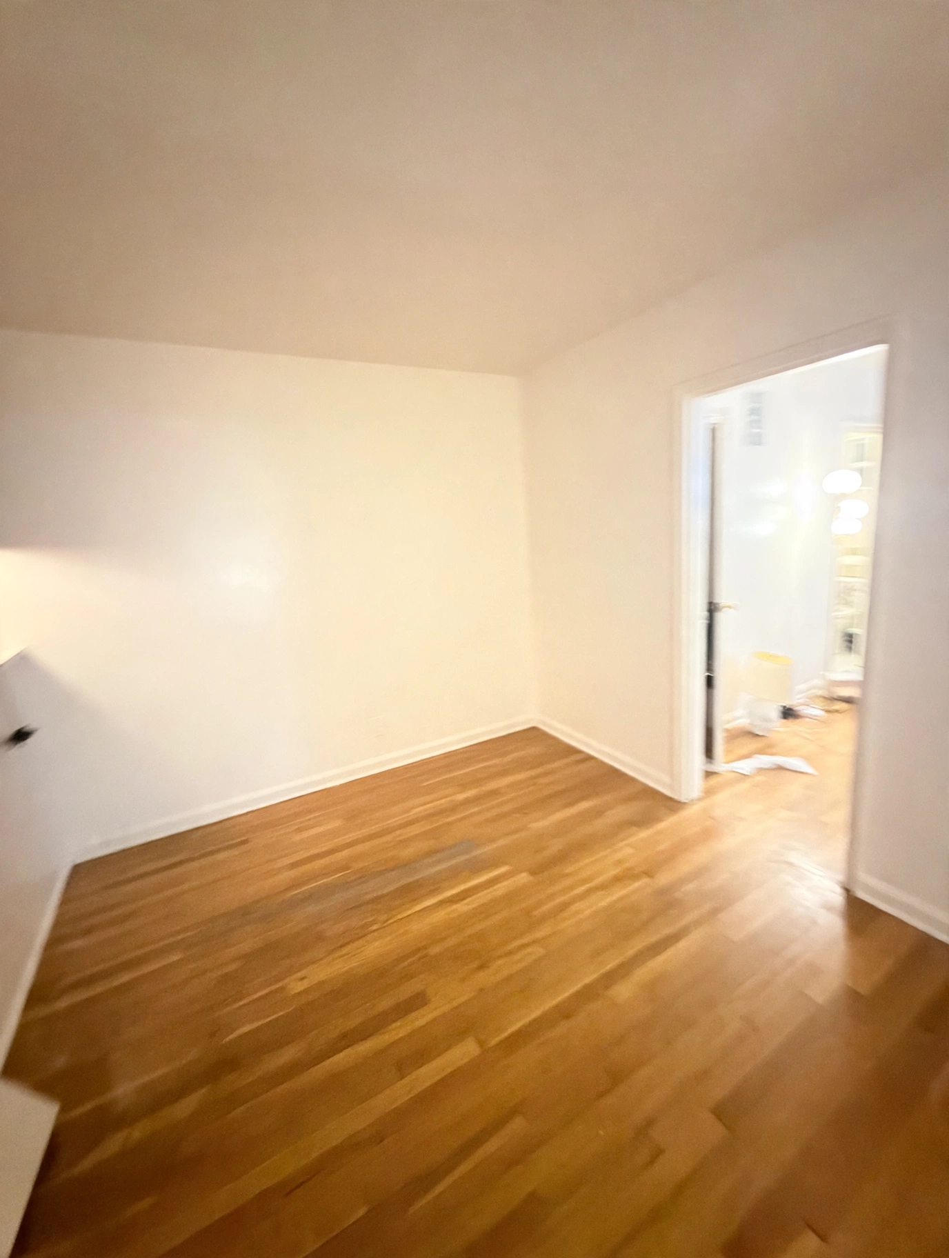 Deluxe Mixed Cleaning move-in / move-out cleaning — clean empty room with polished wood floors ready for move-in